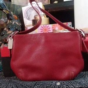 The Classic Burgundy coach elbow to shoulder purse